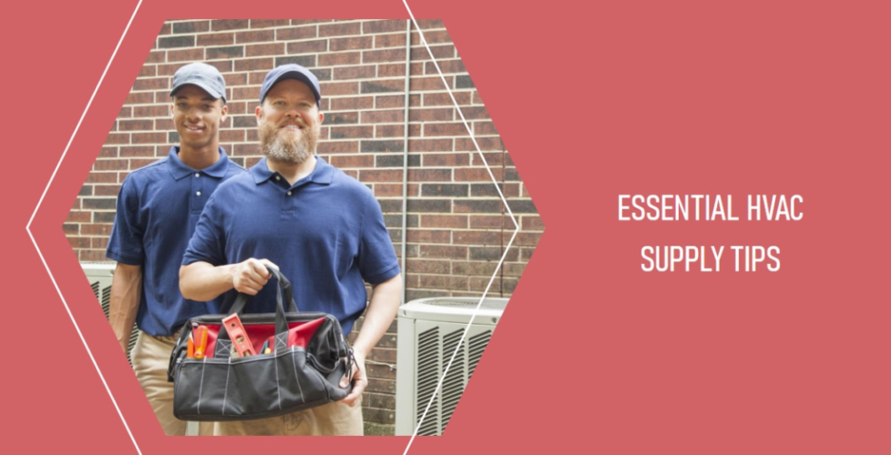 Two HVAC technicians standing outdoors, both dressed in blue uniforms. One holds a tool bag filled with HVAC equipment. The background features an HVAC unit against a brick wall, and the text on the right reads "Essential HVAC Supply Tips.