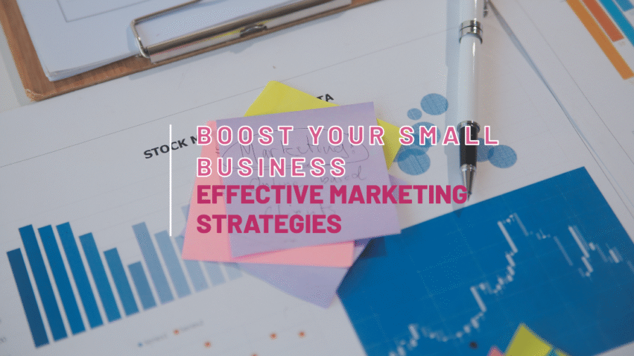 A stack of sticky notes with the text "Boost Your Small Business: Effective Marketing Strategies" on top of charts and graphs.
